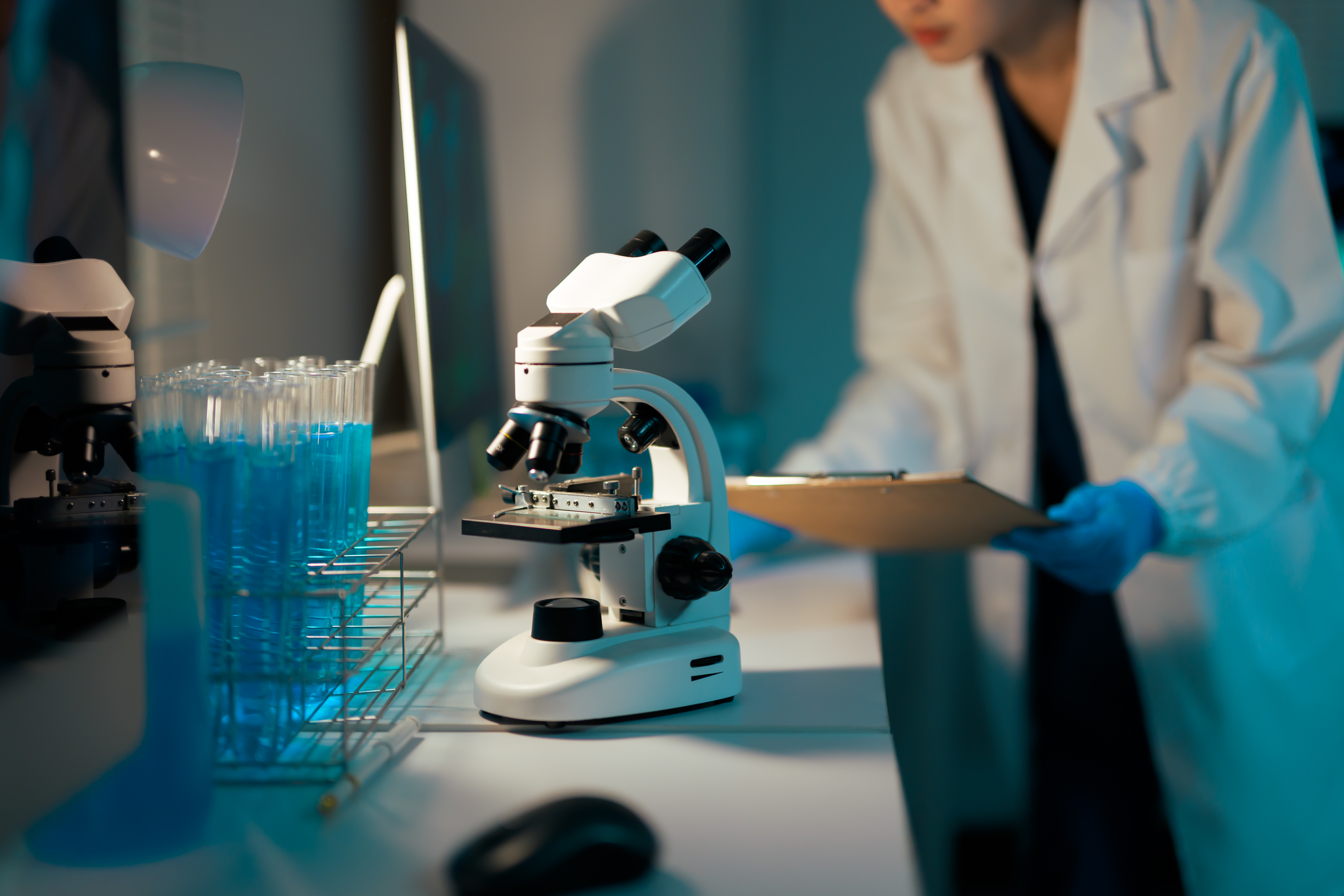 Scientist doing medical research in laboratory with microscope